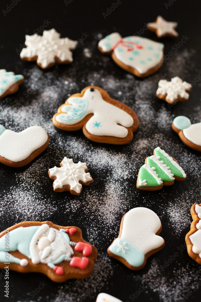 Fototapeta premium Christmas gift gingerbread on dark background. Christmas gingerbread cookies with icing sugar. Top view