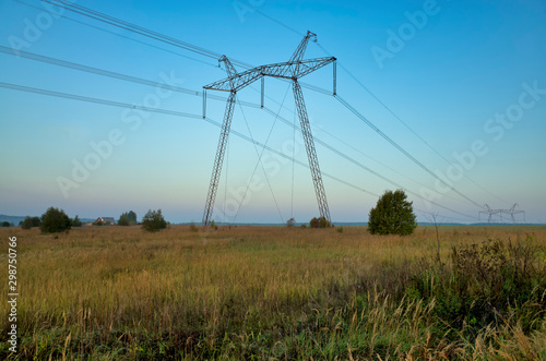 Obraz na płótnie In the village at dawn. Grain sown field, fog, horizon, electric wires and metal power poles, Russia w salonie