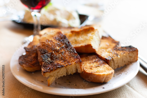 Greek food  roasted bread with olive oil and herbs  red wine and tzatziki sauce