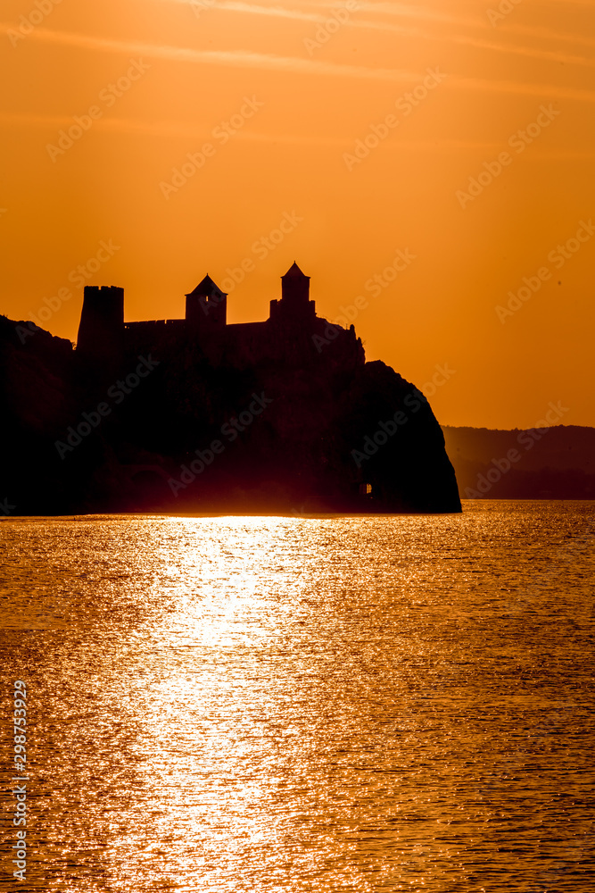 Silhouette of Golubac castle during sunset in Serbia along the Danube 