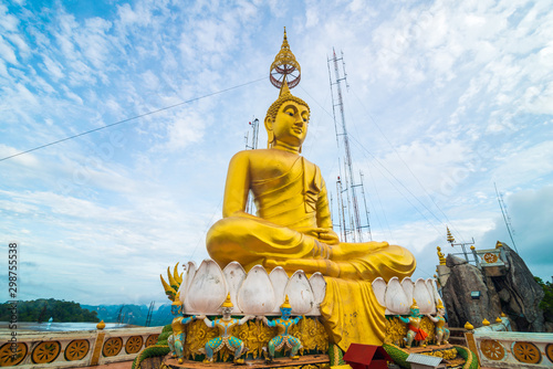 Golden buddha statue locate on peak of mountain