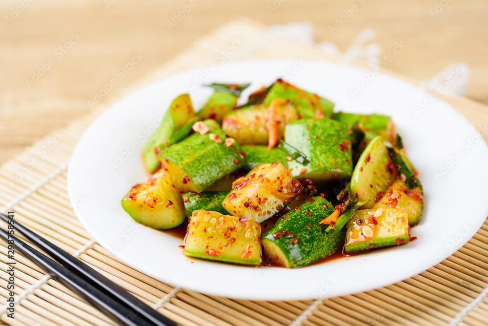 Kimchi cucumber on white plate with chopsticks, Korean food Kimchi cucumber on white plate with chopsticks, Korean food