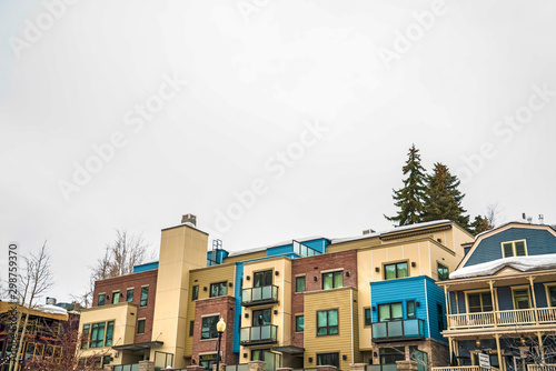 Townhomes facade with balconies in Park City Utah against cloudy sky in winter