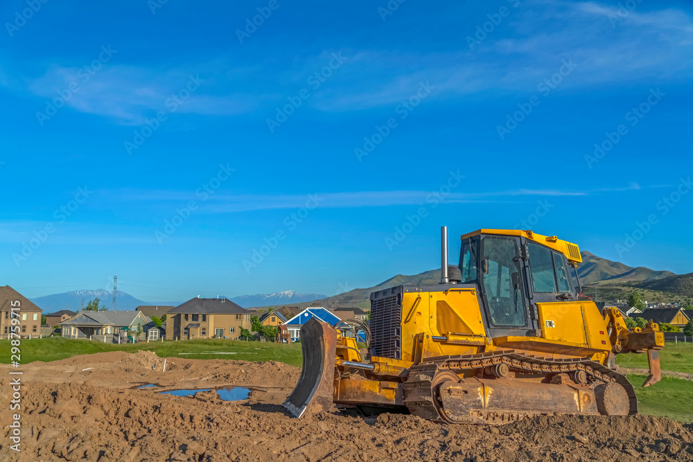 custom made wallpaper toronto digitalBulldozer at a construction site with view of houses and mountain on a sunny day