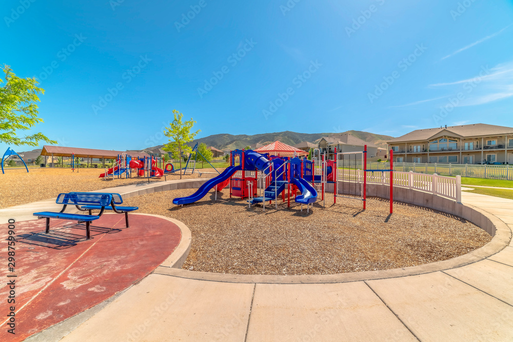 Colorful playground equipment and benches at a park with Mount Timpanogos view Colorful playground equipment and benches at a park with Mount Timpanogos view
