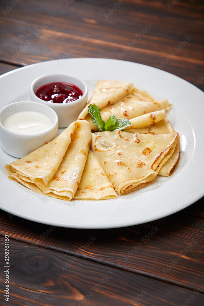 pancakes with sour cream and berry sauce