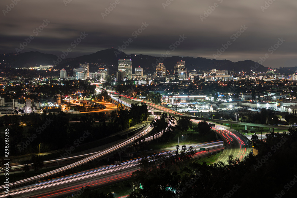 Fototapeta premium Night cityscape view of traffic on the 5 and 134 freeway interchange near Los Angeles, in Southern California. Downtown Glendale is in the background.