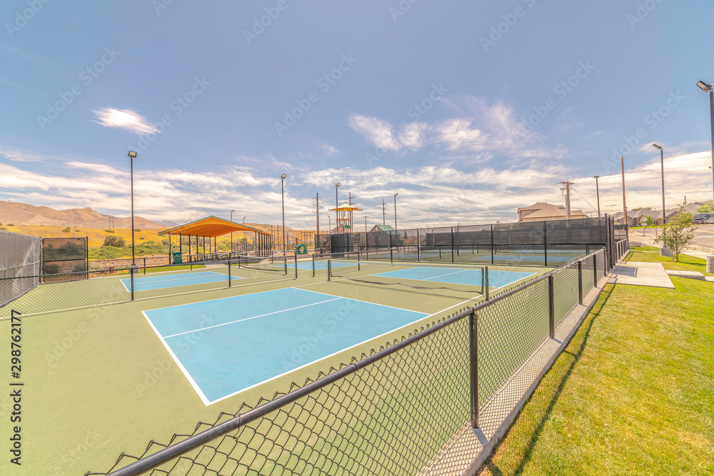 Outdoor tennis courts and sunny recreational park Outdoor tennis courts and sunny recreational park