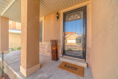 Front door and veranda of modern rendered home