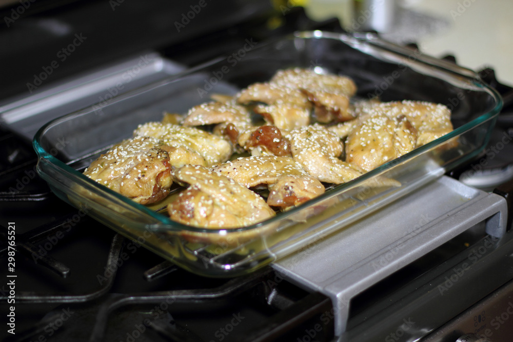 Marinated teriyaki chicken wings about to be baked in the oven. Marinated teriyaki chicken wings about to be baked in the oven.