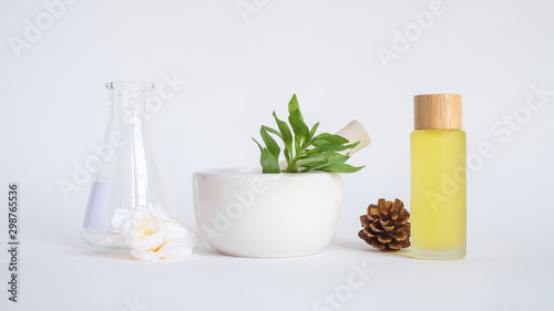 aromatherapy oil with mortar and natural green leaf on white background . aroma skin beauty spa product concept.
