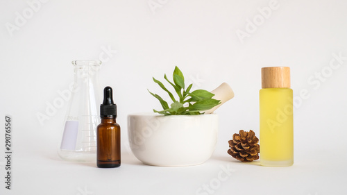aromatherapy oil with mortar and natural green leaf on white background . aroma skin beauty spa product concept.