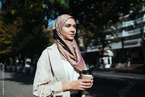 muslim woman in the city center with coffee