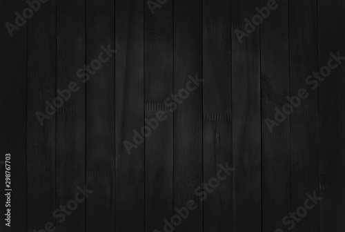 Black wooden wall background, texture of dark bark wood with old natural pattern for design art work, top view of grain timber.
