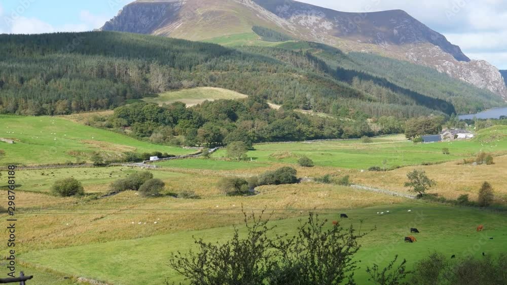 Mountain lake landscape of Snowdonia, North Wales from inside of moving train, handheld camera.