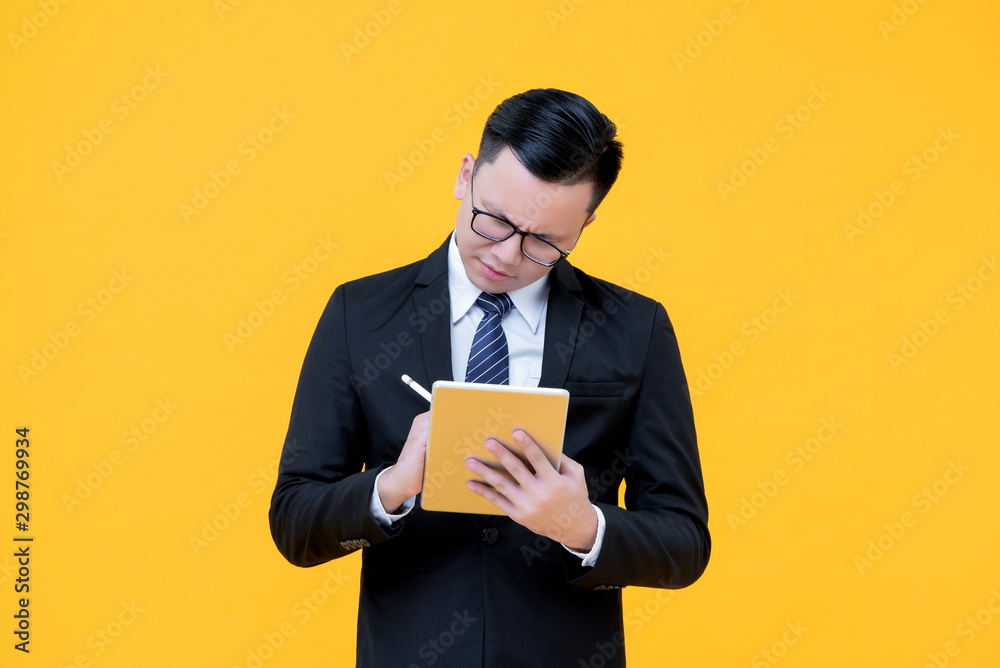 Asian businessman taking note on digital tablet computer Asian businessman taking note on digital tablet computer