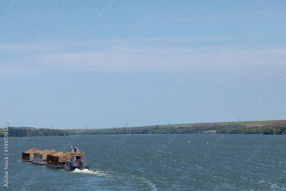 Brazilian ship carrying sugarcane bagasse, sugar cane on the Tiete river.