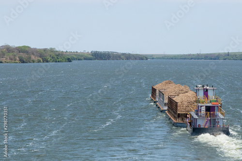 Brazilian ship carrying sugarcane bagasse, sugar cane on the Tiete river. photo