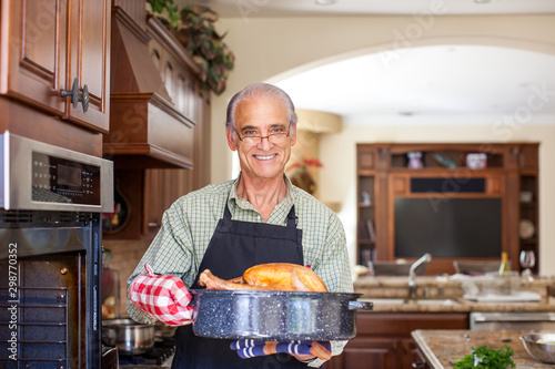 Good looking senior man holding turkey