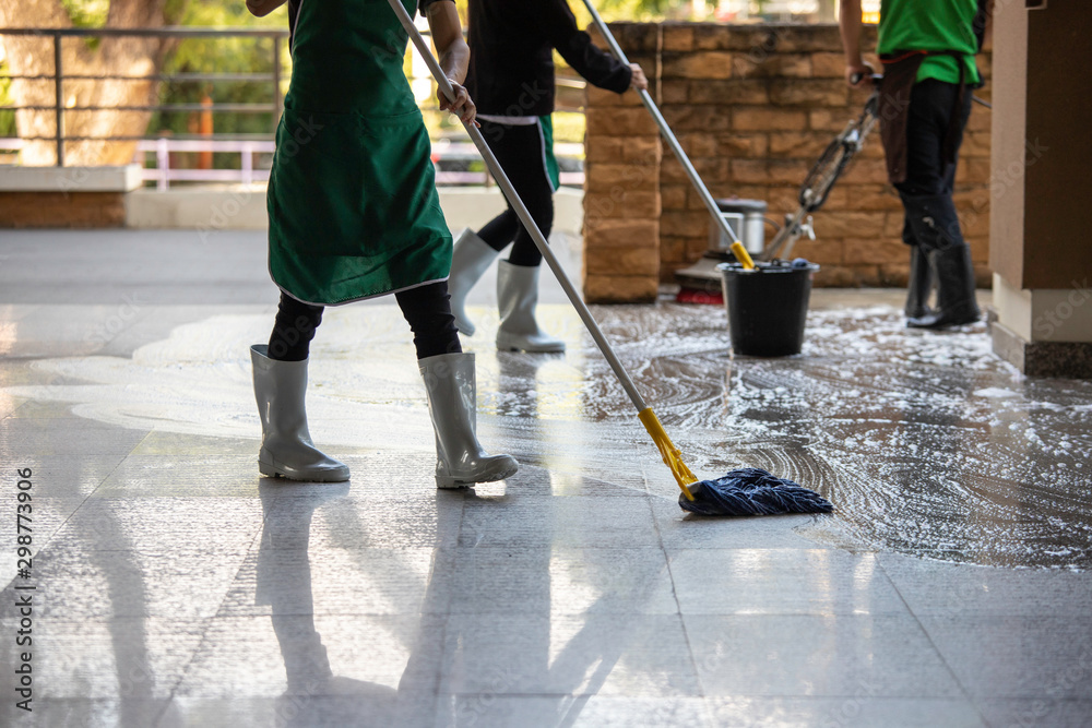 cleaner with mop and uniform cleaning hall floor of public business  building Stock Photo | Adobe Stock