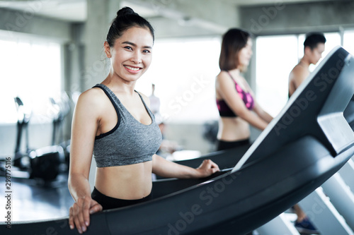 Young asia people run on a treadmill in the gym.