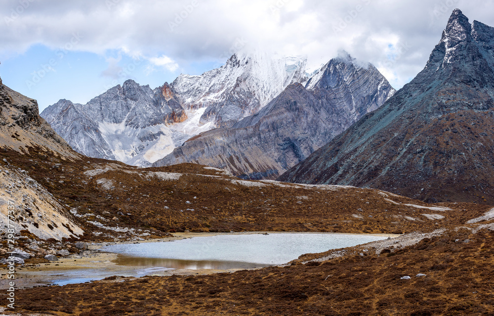 Fototapeta premium Colorful in autumn forest and snow mountain at Yading nature reserve, The last Shangri la