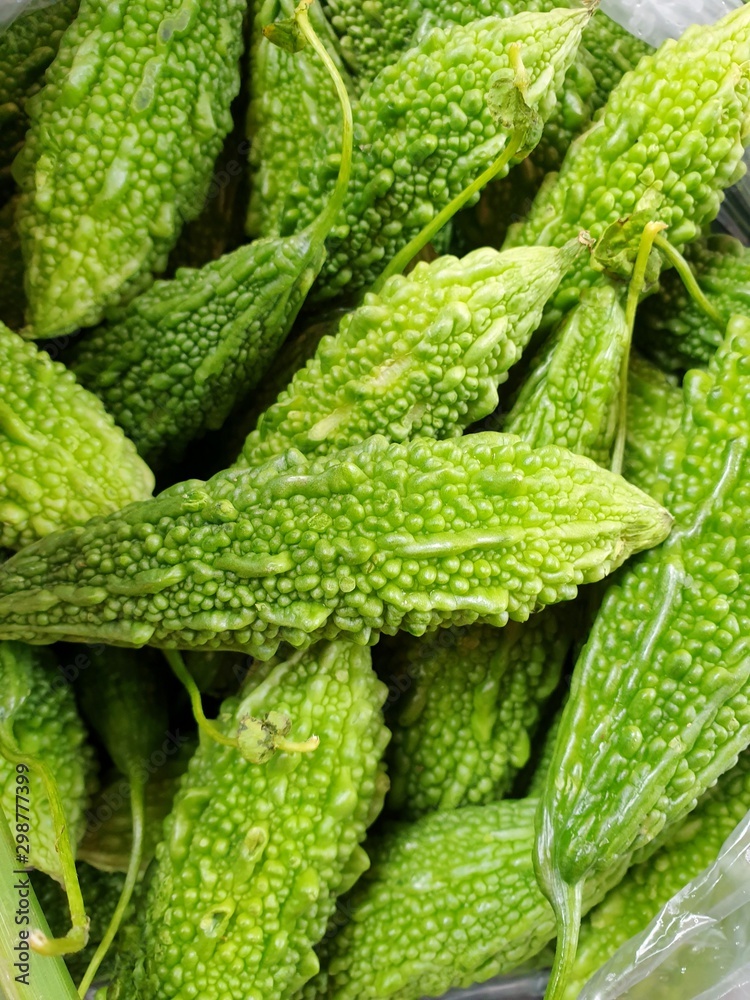 Top view of stack Bitter Cucumber or Balsum Pear as a background for sale in the market at Thailand, abstract background, for cooking, healthy food concept ( bitter melon, Momordica charantia L) Top view of stack Bitter Cucumber or Balsum Pear as a background for sale in the market at Thailand, abstract background, for cooking, healthy food concept ( bitter melon, Momordica charantia L)