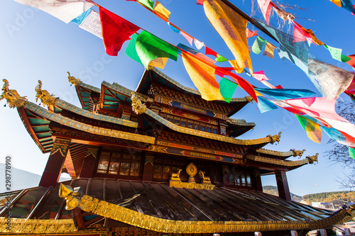 Guishan temple with giant buddhist tibetan prayer golden wheel in old town Shangri la photo