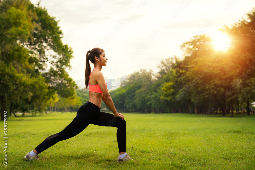 Asian girl warm up before start running in out door park, this image can use for park in city Asian girl warm up before start running in out door park, this image can use for park in city