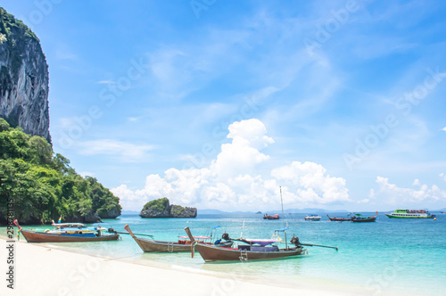 Lots of boat tours and tourists on the beach at Poda island , Krabi in Thailand.