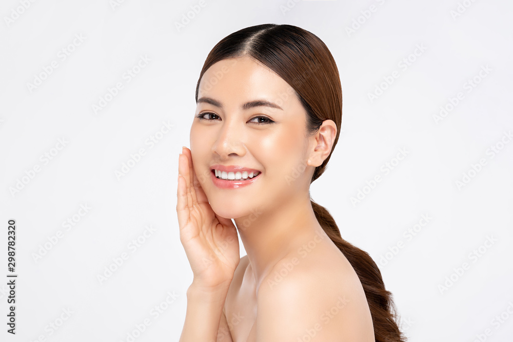 Asian woman smiling with hand touching face for beauty and skin care concepts Asian woman smiling with hand touching face for beauty and skin care concepts