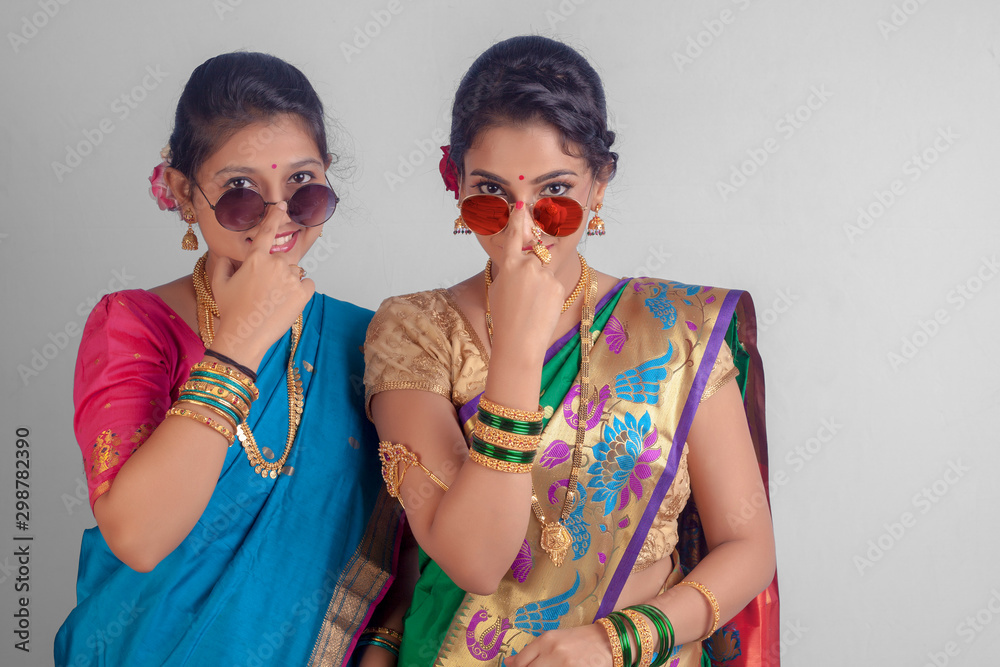 Indian Beautiful young girls in traditional wear saree, Nauvari &  sunglasses. Stock Photo