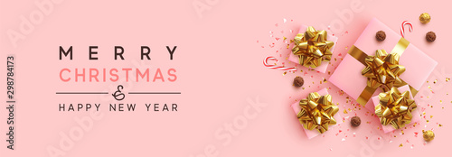 Banner Merry Christmas and Happy New Year. Realistic pink gift boxes, glitter gold confetti, Chocolate round candy in foil, sweet cane. Xmas present. flat lay, top view. Vector illustration