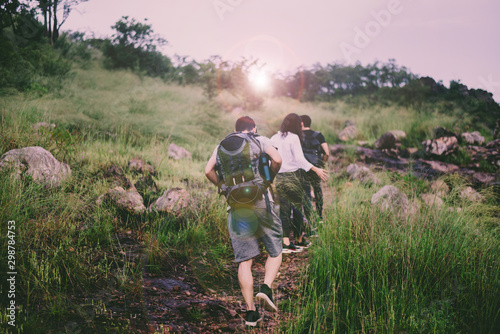 Group of traveler friends walking together at rain forest,Enjoying backpacking concept,Back view