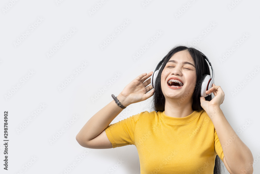 Happy Asian woman using headphone on white background, lifetyle concept. Happy Asian woman using headphone on white background, lifetyle concept.