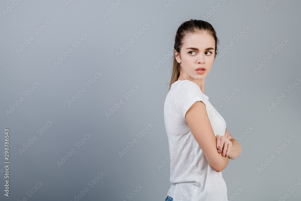 unhappy angry woman with hands crossed isolated over grey unhappy angry woman with hands crossed isolated over grey