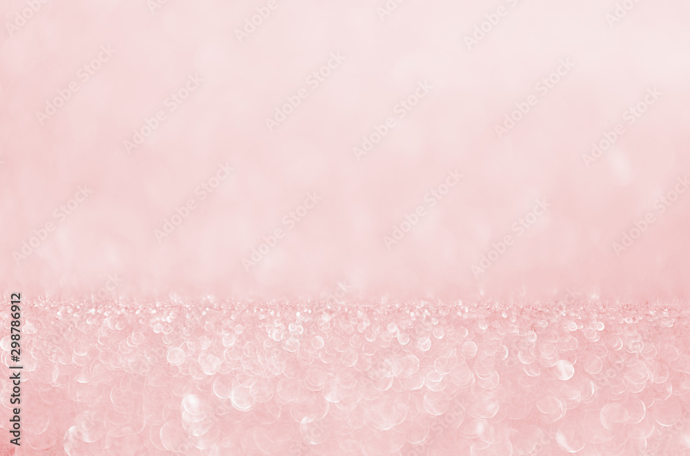Soft light pink shining glowing bokeh abstract texture for Christmas and festive design.