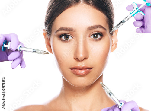 woman advertising concept of lifting skin using beauty injection iasolated on white. lot of syringes around a female face. non-surgical cosmetology photo