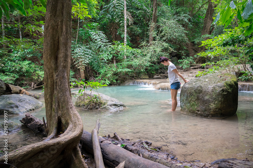 young cute hipster girl travelling at beautiful Erawan waterfall mountains  green forest hiking views at Kanchanaburi  Thailand. guiding  idea for female backpacker woman women backpacking