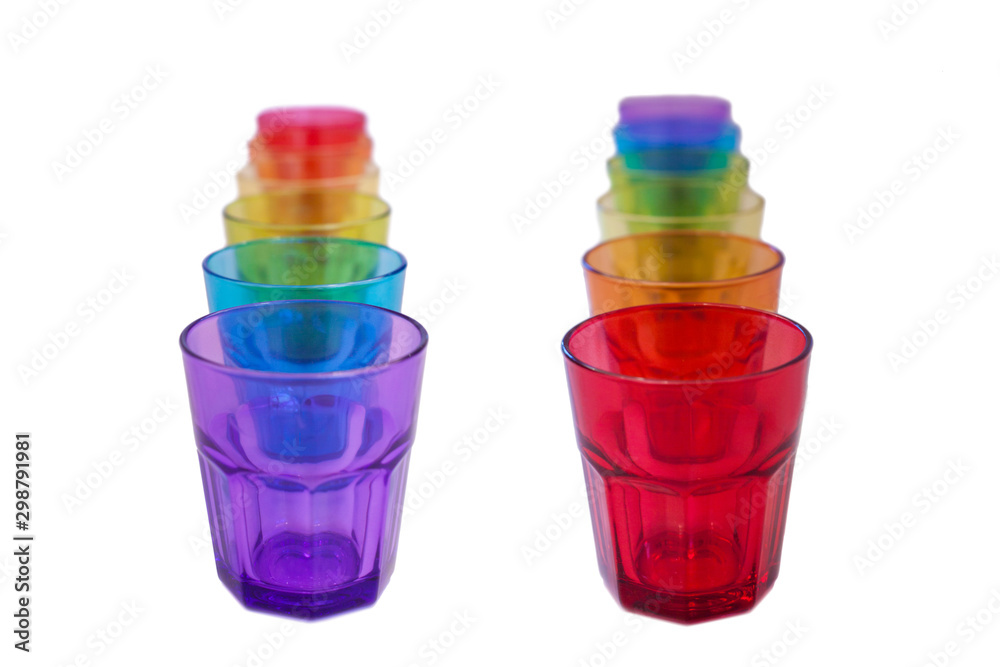 multi-colored glass on a white background. containers made of glass, ordered by the rainbow color spectrum, isolated, purple, blue, green, yellow, orange, red, with clipping path. multi-colored glass on a white background. containers made of glass, ordered by the rainbow color spectrum, isolated, purple, blue, green, yellow, orange, red, with clipping path.