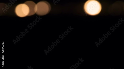 Candlefire Resurrection from the Darkness. Field burning candles close-up. Candles begin to light up in the distance and the lights gradually approach the chamber. Filmed at a speed of 120fps photo