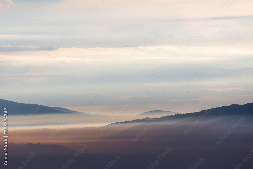 A view of Umbria valley with hills and fog