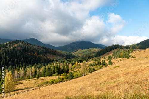 Amazing mountain landscape with colorful vivid sunset on the blue sky