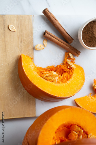 pumpkins with cinnamon sticks on marble backgrund photo