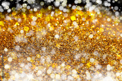 Glitter lights gold or yellow grunge background. Glitter defocused abstract Twinkly Lights and Stars Christmas Background © Alik Mulikov