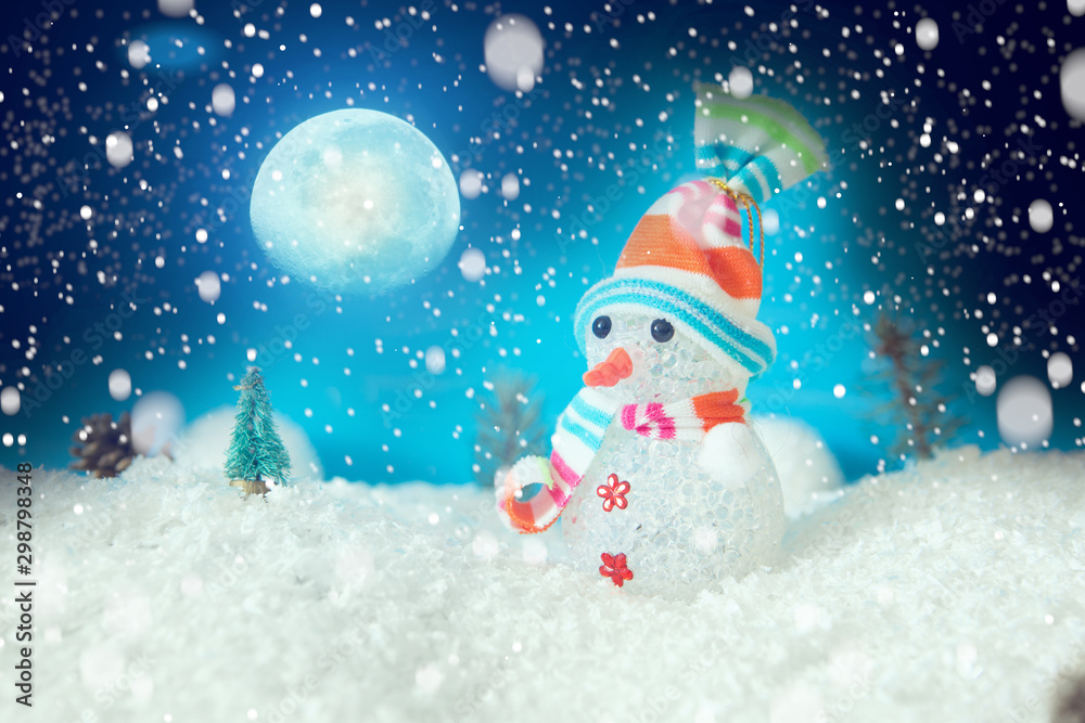 Fototapeta premium Christmas snowman with Xmas lights and snow on moonlights. The elements of this image furnished by NASA