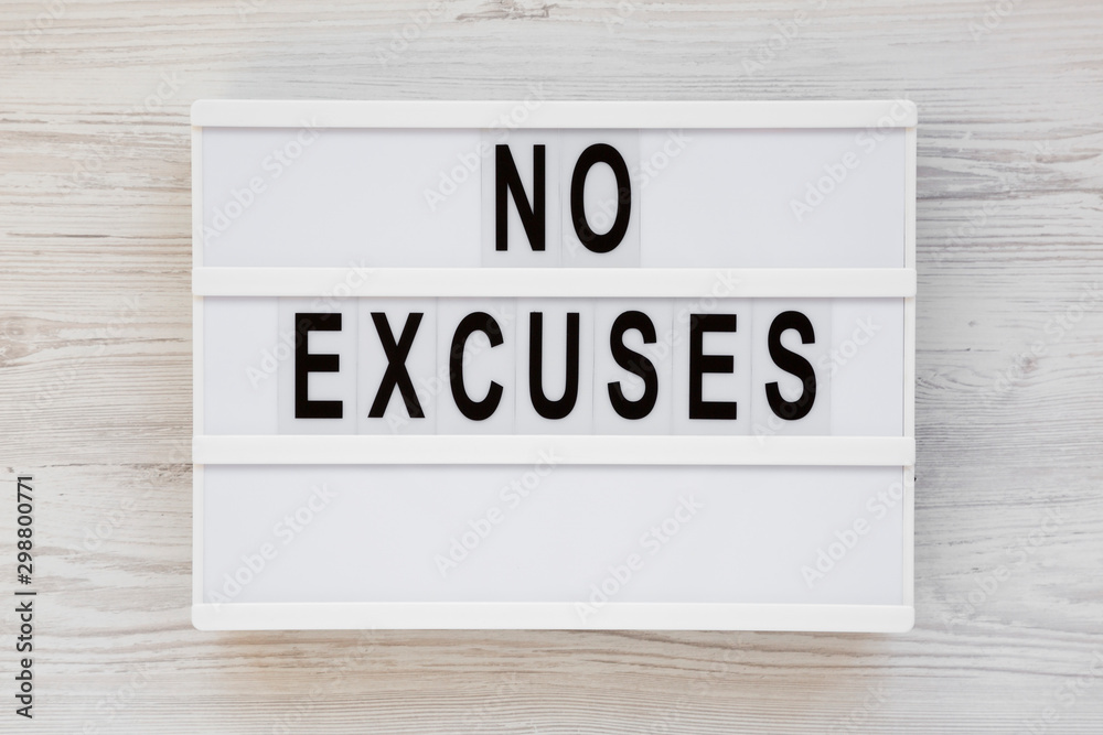 'No excuses' words on a modern board on a white wooden surface, top view. Overhead, from above, flat lay. 'No excuses' words on a modern board on a white wooden surface, top view. Overhead, from above, flat lay.
