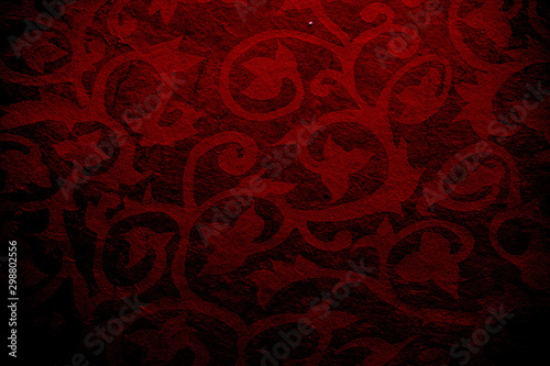antique colored paper background texture with dark in old distressed vintage design. Colour of paper red, christmas texture