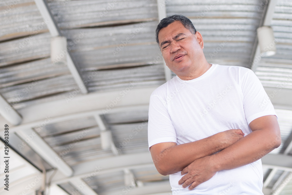 Fototapeta premium old senior man with stomach ache; retired man suffering from stomachache, abdominal pain, diarrhea; constipation; food poisoning, gastritis, acid reflux; stomach cancer