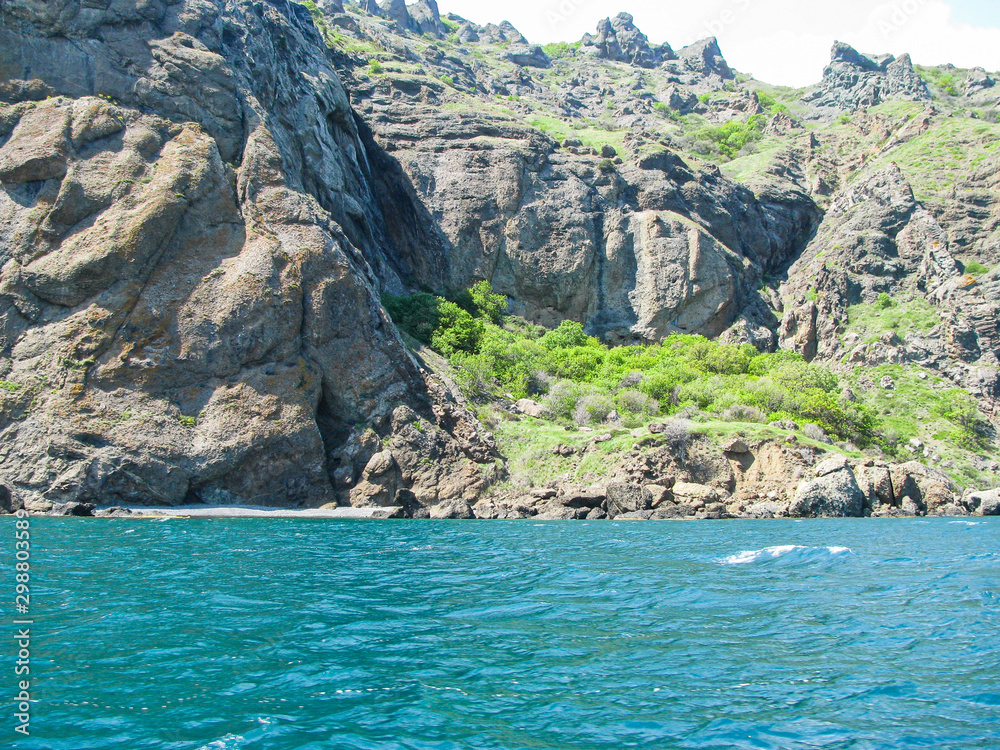 Crimea, a Steep Rocky Coast, Caves, Frozen Stone Figures, Beautiful Azure Sea Waves